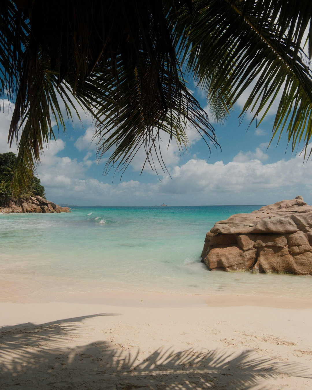 Turquoise lagoon and white-sand beach in the Seychelles for a luxury island escape